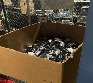 A box of hard drives sits inside a secure cage