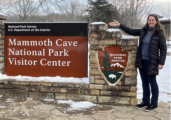 Marta Young on side of Mammoth Cave National Park Sign for Visitors Center