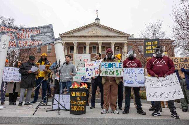 Picture of people rallying in Annapolis with signs like "Burning trash is not clean energy," "for the air we breathe," and "let's reclaim renewable energy."