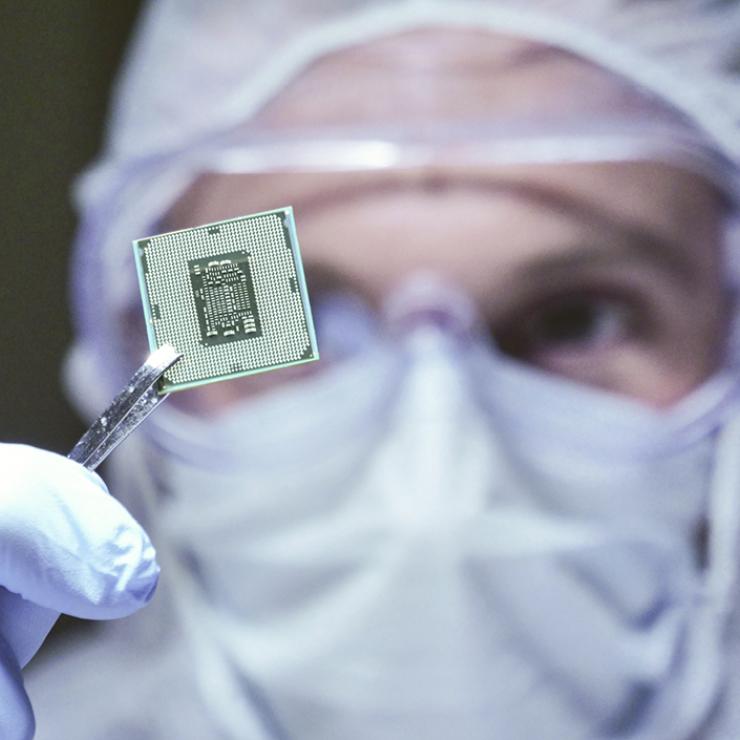 Lab worker holding a microchip