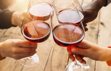 Image of people toasting wine glasses