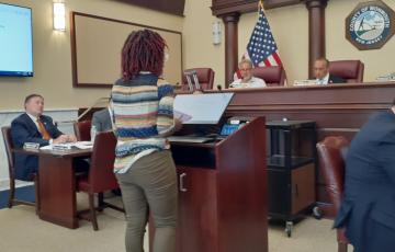 Image of Clean Water Action's Tolani Taylor testifying at NJ Warehouse Hearing