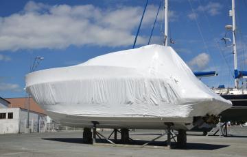 Boat wrapped in white heat shrink plastic. 