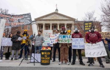 A rally in front of the State House in Annapolis with people holding signs like "Burning trash is not clean energy"
