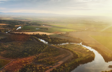Pesticides being sprayed next to a river running through California