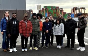 A dozen advocates standing by an industrial port in New Jersey