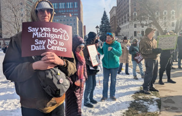 Protestors holding signs including "say yes to Michigan, say NO to data centers"