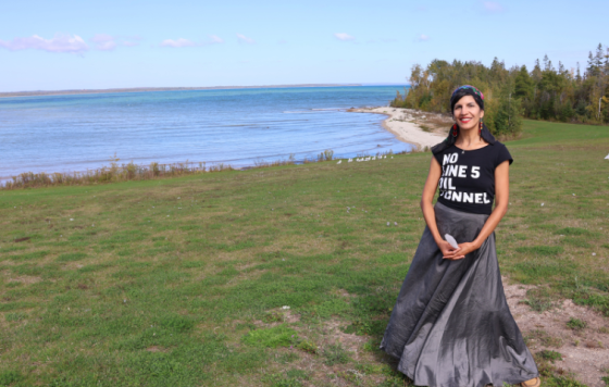 Dr Nichole Keway Biber next to Lake Huron wearing a "No Line 5 Tunnel" shirt. 