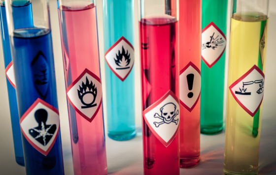 Test tubes of chemicals with warning labels
