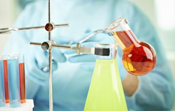 Chemicals being mixed in beakers. Photo credit: mediaphotos / Shutterstock